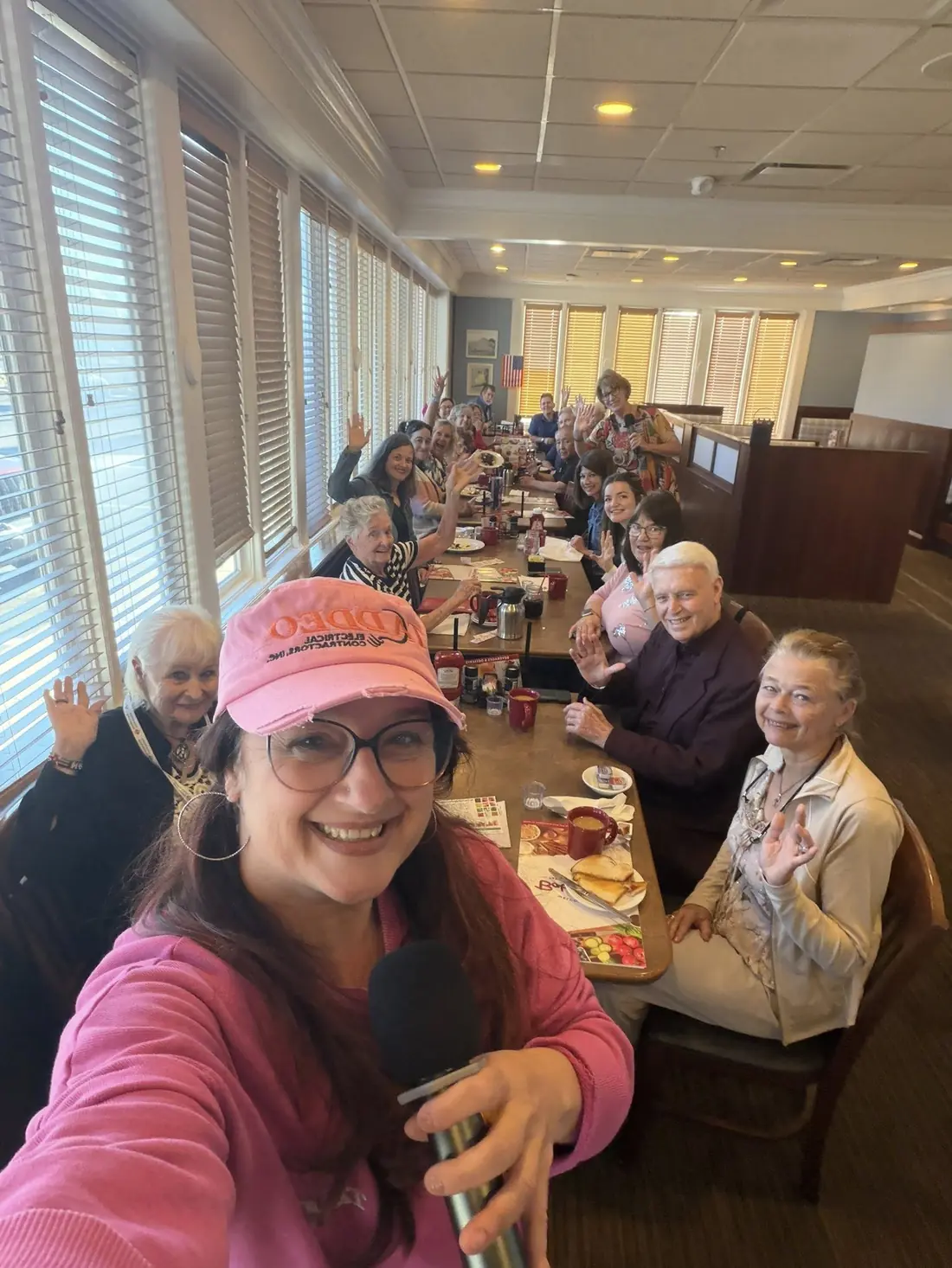 A warm group selfie of TPBG members at a Monday morning meeting
