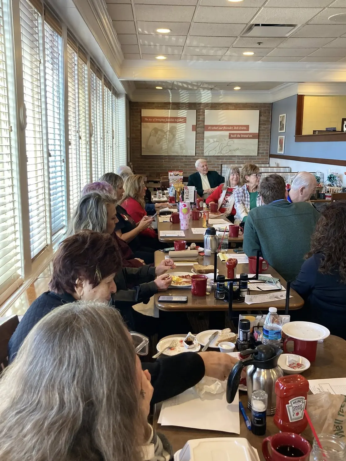 Members gathered around a long table at Bob Evans