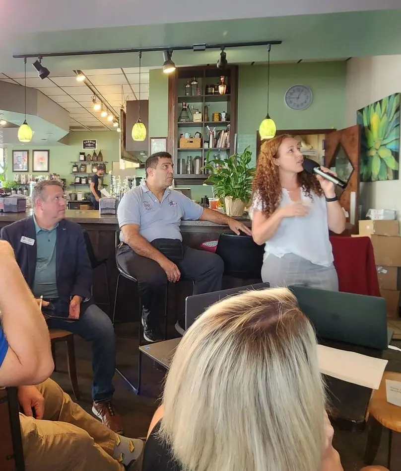 A member singing into a microphone for the group