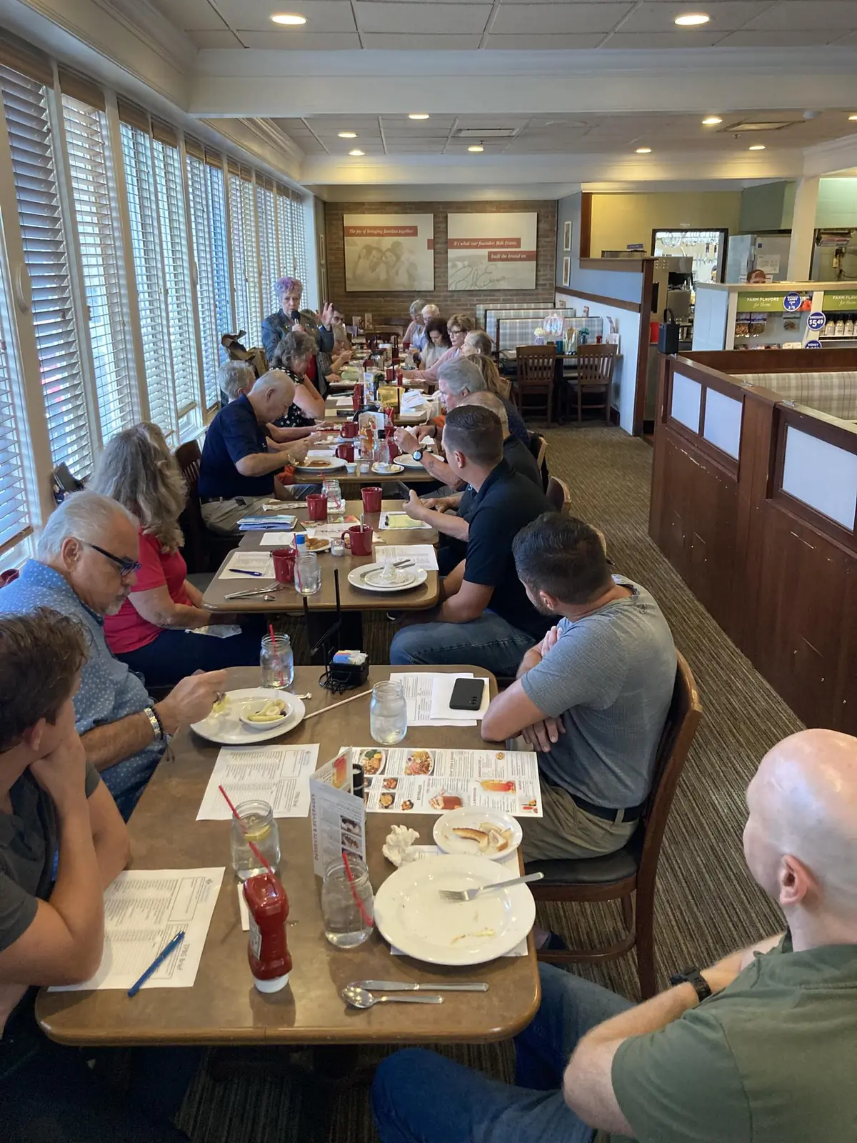 TPBG members across multiple tables at a Monday morning meeting
